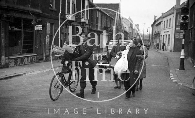 People made homeless by the bombing, carry what possessions they could salvage, Monmouth Place, Bath 1942