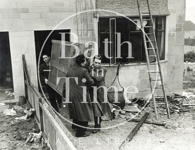 Removing furniture from bomb damaged 28, Stirtingale Avenue, Kingsway, Bath 1941