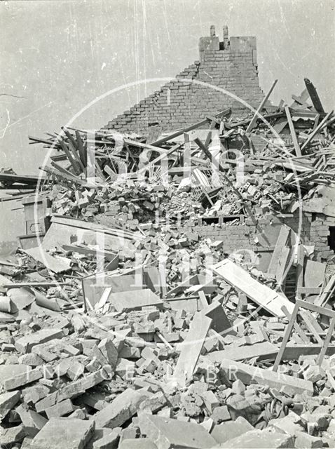 A child's cot amongst the rubble of a destroyed home in Bath 1942