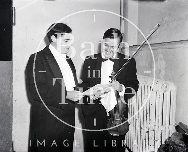 A violinist from the Philharmonia of Bath inspects the music score c.1970?