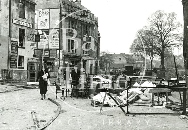 Walking past a pile of salvaged furniture on the Upper Bristol Road, Bath 1942