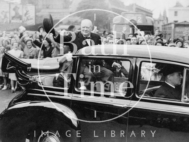 Winston Churchill in an open topped car being cheered by the public lining the route, bath 1950