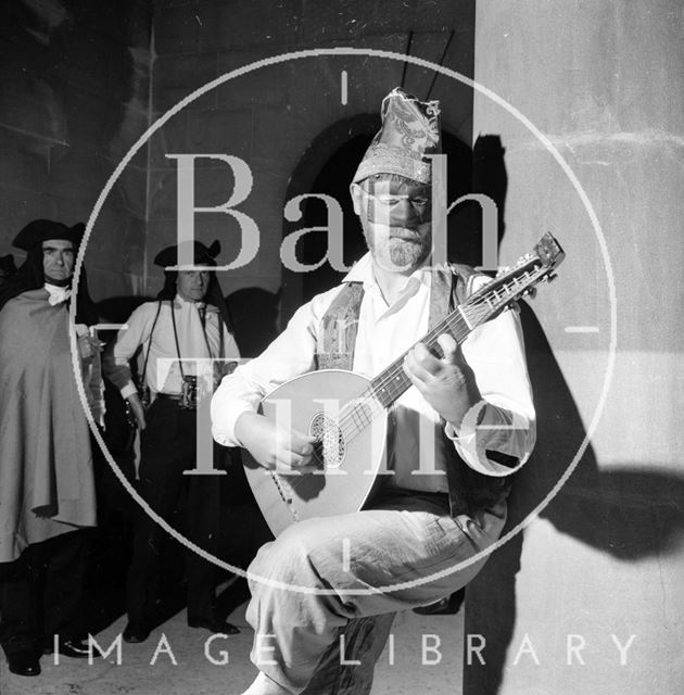 A troubadour provides background music for the guests at La Serenissima, Bath 1962