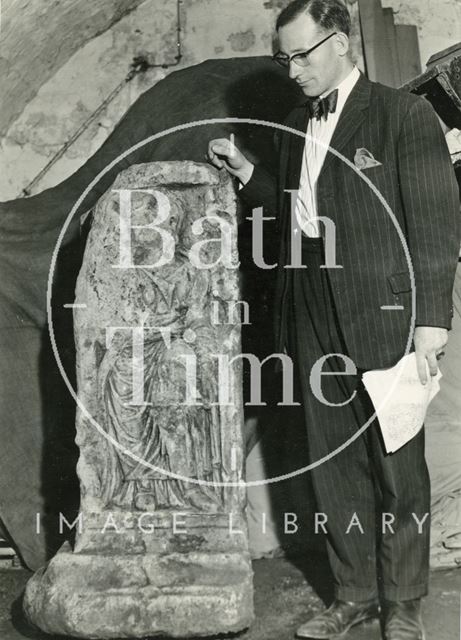 Michael Owen, curator of the Roman Baths with a piece of the Roman Altar, Bath c.1960