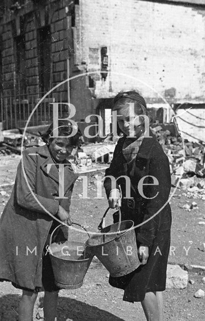 Two girls pose with fire buckets in front of 19, Green Park, Bath 1942