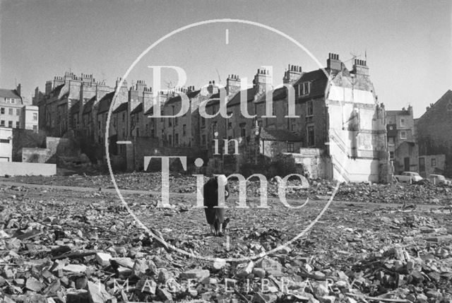 An elderly lady returns to the site of her home, Lampard's Buildings, Bath c.1973