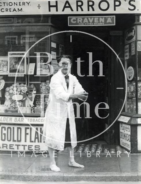 Mr. Arthur Harrop mops up his shop in Weston Village, Bath 1968