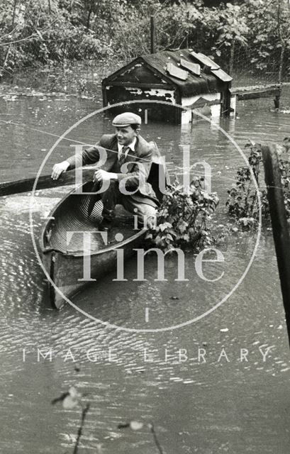 Mr. G. Mealing in the canoe he used to rescue birds from a flooded fowl house, Batheaston 1960