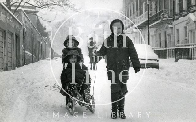 Children tobogganing in Upper Church Street, Bath 1982