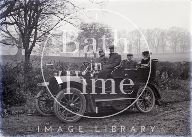 A family being driven in their motor car c.1910?