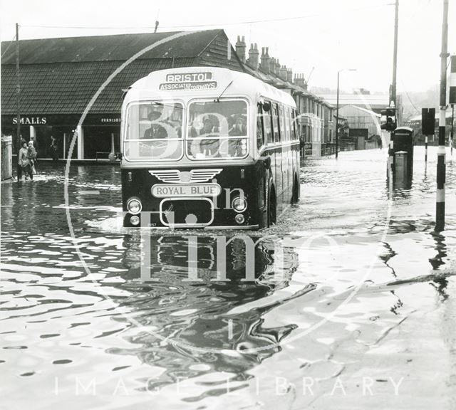 A Bristol Associated Motorways Royal Blue coach splashes through the floods, Bath c.1968