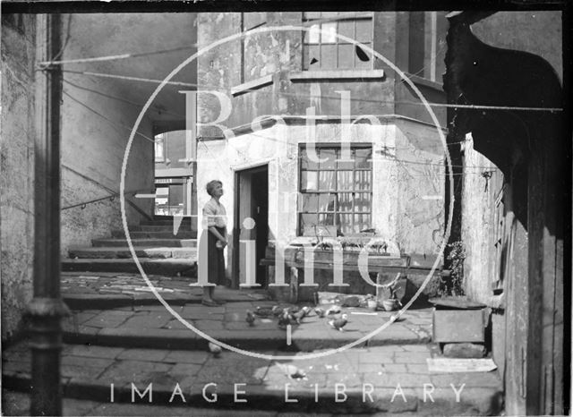 Feeding the pigeons, Parsons Yard, behind Walcot Street c.1930s