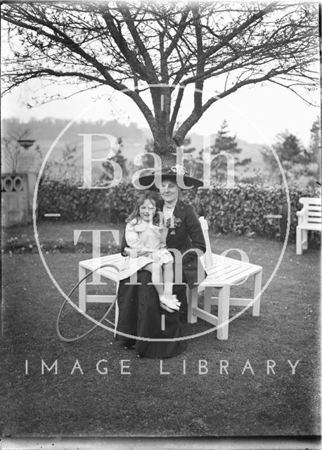 Mother, daughter and toy hoop in the gardens of Monkton House, Warminster Road, Limpley Stoke, Wiltshire c.1910