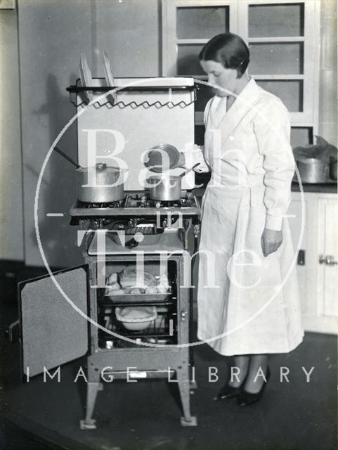 Lady and oven cooking c.1930