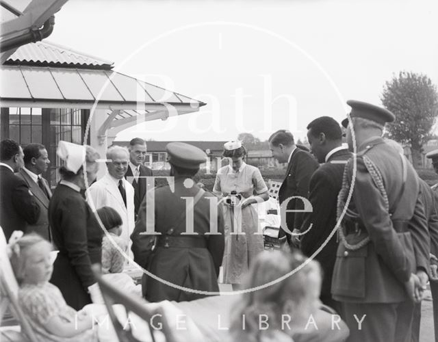 Emperor Haile Selassie poses for the camera as a nurse takes his picture, Bath 1954