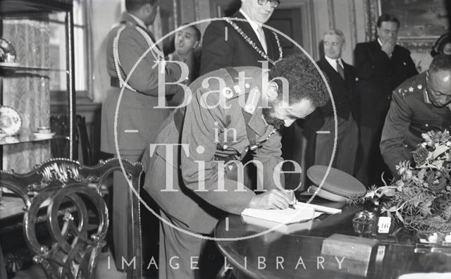 Emperor Haile Selassie signing the visitor's book in Bath during an official visit 1954