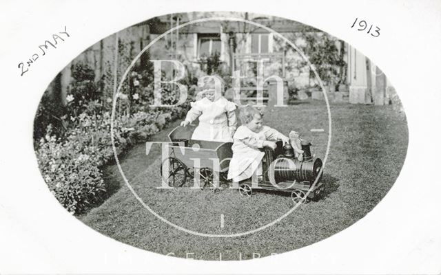 The photographers twins playing with their toy train in the garden of 32, Sydney Gardens, Bath 1913