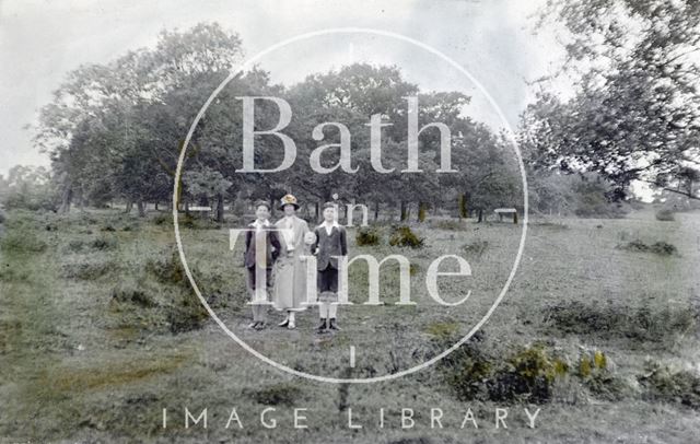 A crudely tinted photograph of the photographer's wife Violet and twin boys on Bathampton Down c.1923