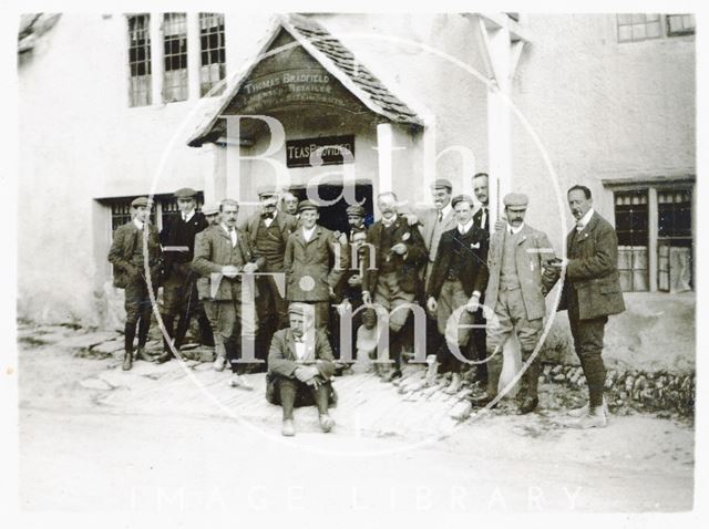 The photographer and a group of men pose outside a tea room at Castle Combe, Wiltshire c.1892