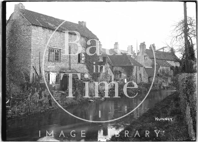 Houses in Nunney, Somerset, viewed across the stream c.1920