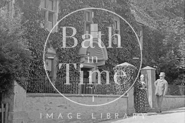 View of a fine house in Castle Combe, Wiltshire with figures in the foreground c.1900 - detail