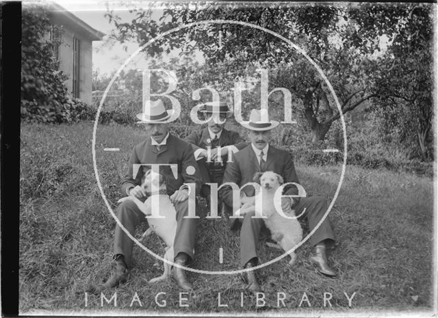 Three Gentlemen and two dogs in the grounds of an unidentified house c.1910