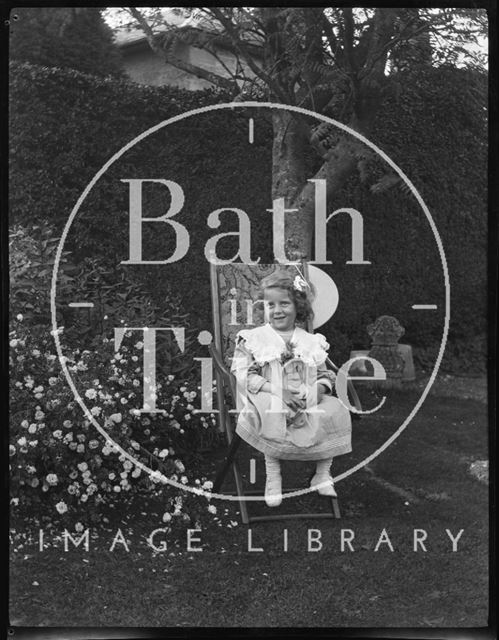 A delightful portrait of a young girl in the garden c.1900