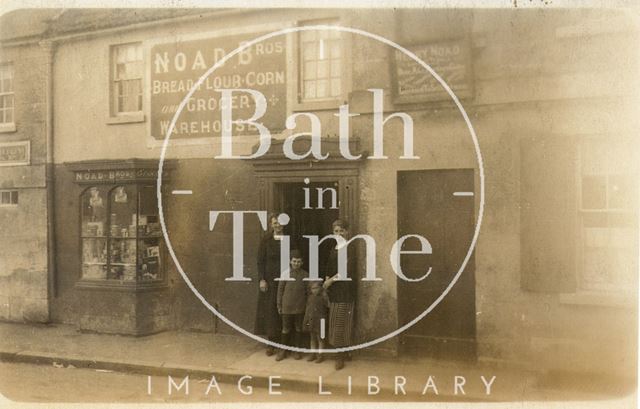 Shopkeeper posed on the steps of Noad's bakers, Bath c.1910