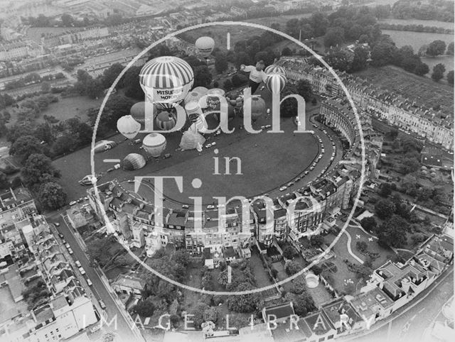 Aerial view of the rear of Royal Crescent, Bath with a mass balloon launch on the Crescent Lawn in front