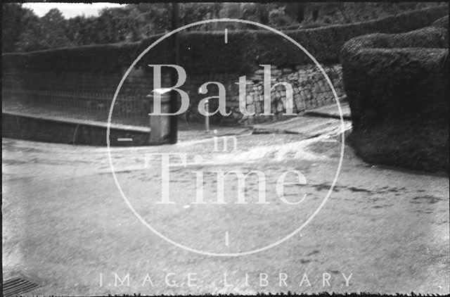 Floodwater running down a path in Sydney Buildings, Bath 1932