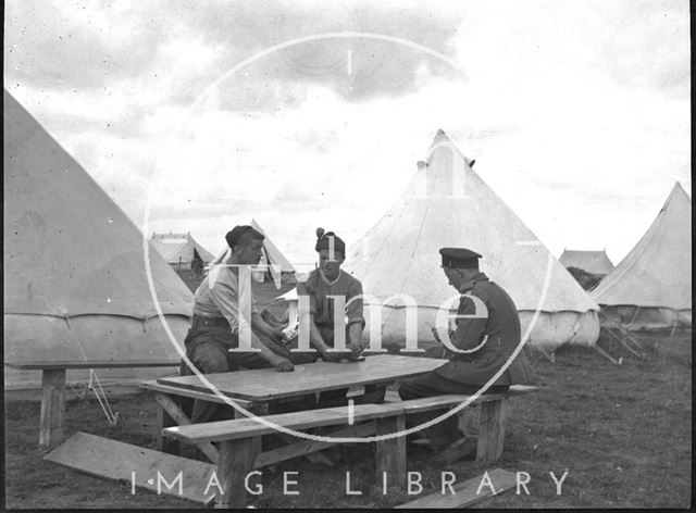 Off duty playing cards at an unidentified military camp c.1900