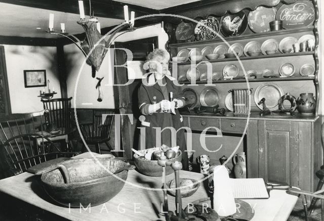 A cleaner inside one of the display rooms at the American Museum in Britain, Claverton 1992