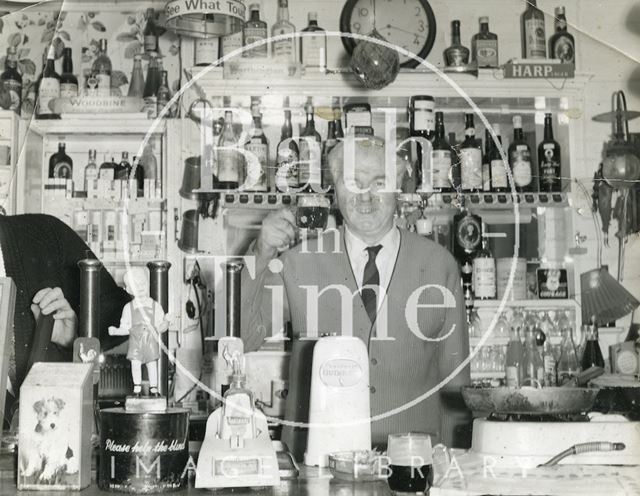 Tom Harper, landlord of the Larkhall Inn, Bath, behind the bar 1960s