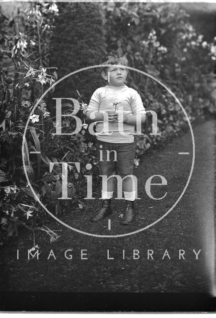 Portrait of a small boy in a garden c.1915