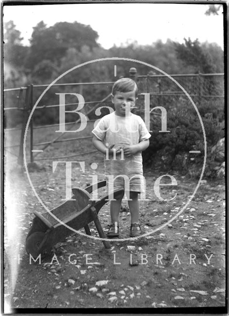 A boy with a wheelbarrow c.1920