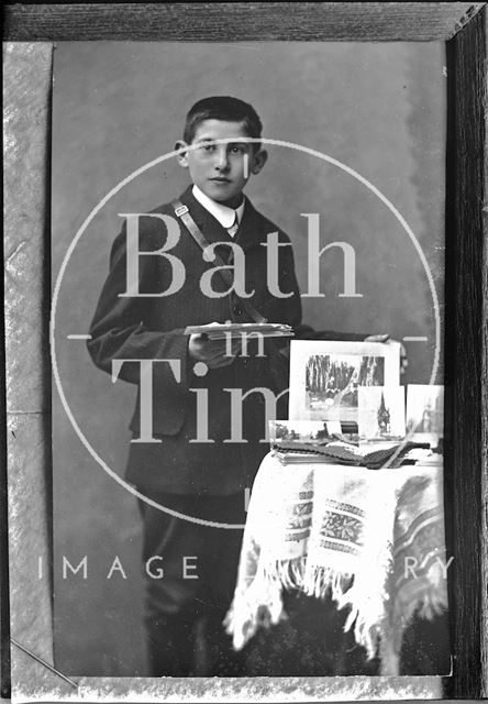 Portrait of a young man with some photographs c.1890