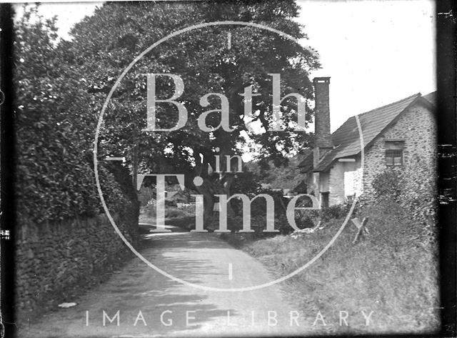 An unidentified building on a country lane c.1900