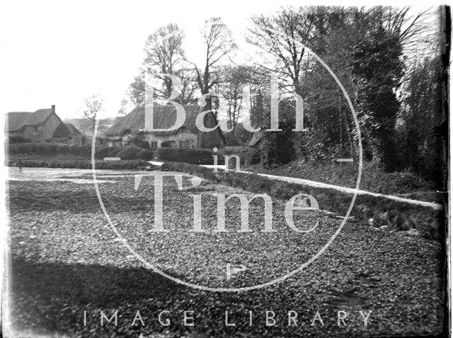 An unidentified lane with thatched cottages c.1910