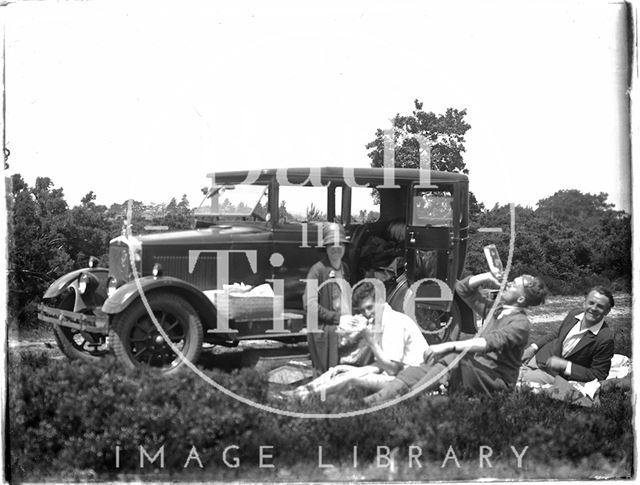 A picnic party with the car in the background c.1920