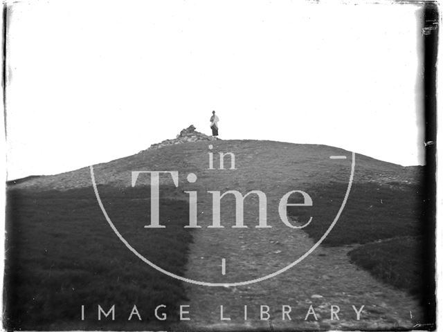 The photographer's wife Violet sitting next to a pile of rocks, Dunkery Beacon, Somerset c.1920