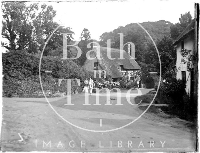 An unidentified village scene with thatched cottage c.1920