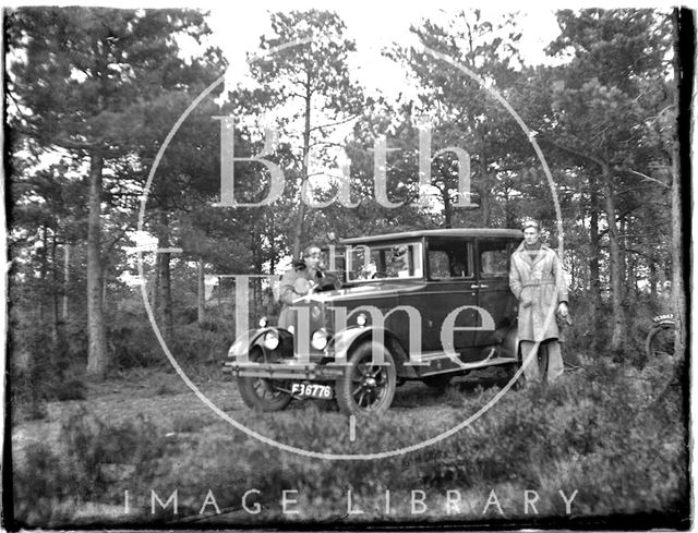 Posing beside the photographer's car c.1920