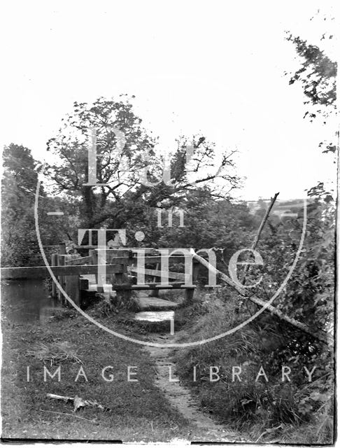 A wooden bridge over an unidentified river or canal c.1920