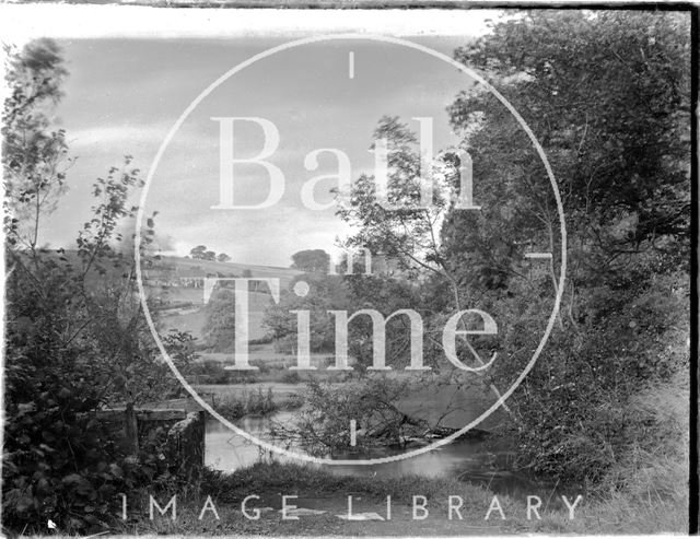 A picturesque riverside scene c.1920