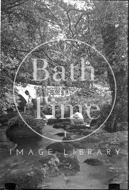 The photographer's twins by a stream in a forest near Brixham, Devon c.1930