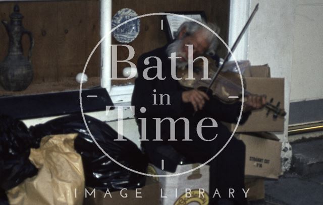 A violin playing busker in Bath 1984