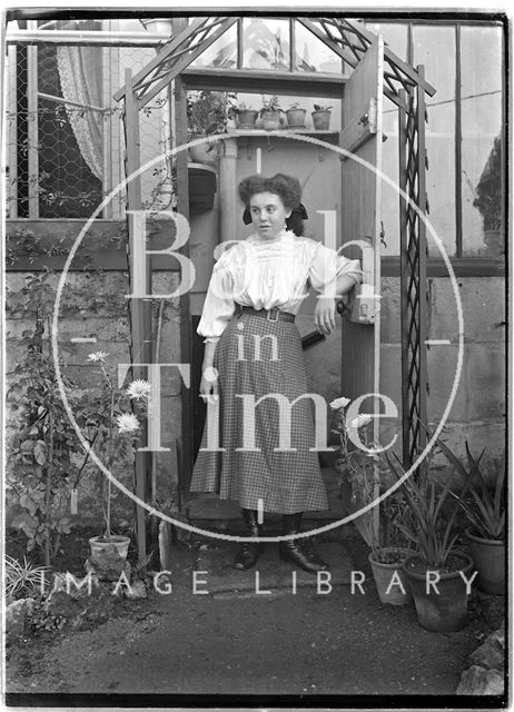 Lady in the doorway to a greenhouse c.1906