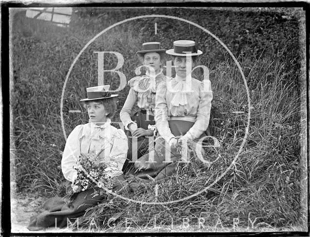 Three ladies in a meadow, possibly at Bathampton Down c.1900