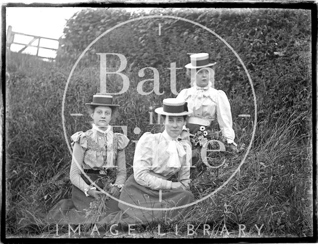 Three ladies in a meadow, possibly at Bathampton Down c.1900