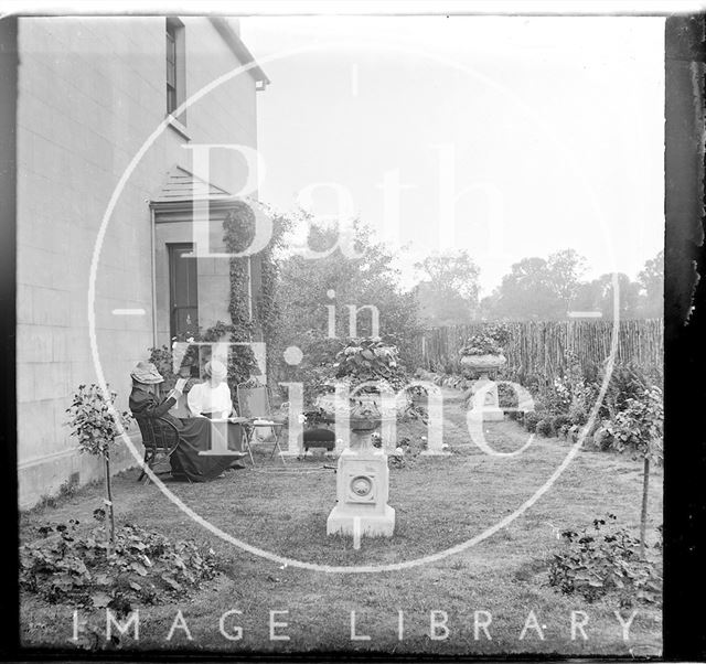 Two ladies sitting outside an unidentified house c.1900